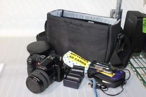 lot 141 image: Leica V Lux 1 Camera with Wide angle Lens  and accessories, Batteries charger, SD Card, Case and More