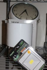 lot 155 image: I home lamp and speaker combo, Wall Clock, and cordless Light
