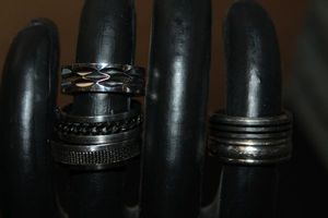 lot 284 image: Five (5) Mens Rings, 3 are Stainless Steele 2 are Titanium and have B&M On the inner Band of both