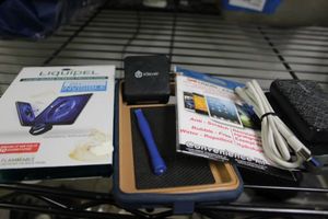 lot 390 image: Liquipel Liquid Screen Protector, and Two Packs Liquid Armor Screen protector... 2 Battery Packs and a wall plug