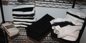 lot 467 image: Two 800 ct. Pillow Cases SIP and a Combination of White and Black Linens as shown in photos