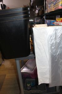 lot 319 image: Wire Basket Full of Medium size Trash Bags and 4 Rubbermaid commercial Trash Can