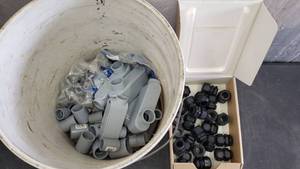 lot 103 image: Large Quantity of 34 PVC Access Elbows, Conduit Clamps & Compression Fittings
