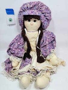 lot 100 image: LARGE RAG DOLL IN A PURPLE DRESS
