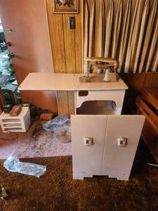 lot 222 image: Vintage Singer Sewing Machine Model 500A with cabinet and built in chair and storage
