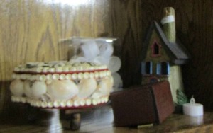 lot 63 image: seashell design piano dcor- travel card game- tea light candles and more