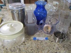 lot 90 image: measuring cups - canisters- blue vase- plastic covered bowl