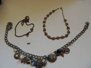 lot 704 image: GOLD NECKLACE - AVON  CHARM NECKLACE WITH 17 CHARMS     CHAIN