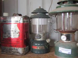 lot 26 image: 2 green Coleman lanterns, full jug of fuel