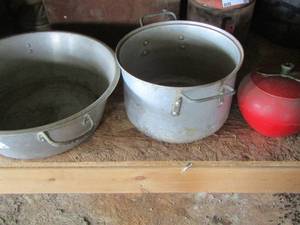 lot 91 image: Large dB handled aluminum pots- strainer- apple design covered bowl plus