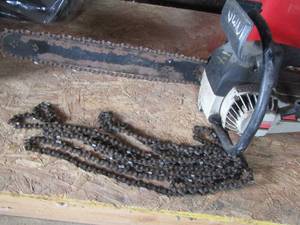 lot 102 image: Craftsman chainsaw with various chains