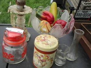lot 164 image: clear glass fruit bowl, wax fruit, tin cans, vase, orange covered jar
