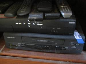lot 486 image: Daewoo cassette player with 7 various remotes