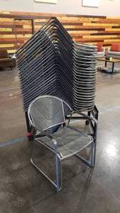 lot 19 image: Lot of 24 Industrial Style Stackable Metal Chairs w Rolling Storage Cart