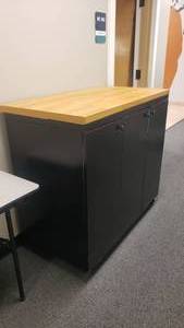 lot 447 image: Large Rolling Storage Cabinet w Butcher Block Top.  Measures 49 x 43 x 25.5