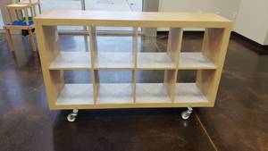 lot 547 image: Ikea Kallax Natural 8 Shelf Shelving Unit w ROLLERS.  Measures 59 x 31 x 15