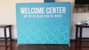 lot 600 image: Large Welcome Banner w Free Standing Frame.  114 x 92