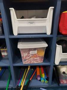 lot 1211 image: Contens of Shelf.  Misc Games.  Giant Ostrich Eggs, Pom Poms, Golf Clubs & Water Squirters