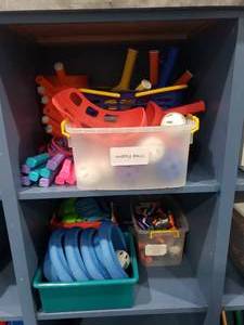lot 1213 image: Contents of Shelf.  Wiffle Balls & Wiffle Ball toss Game, Soft Baseball Gloves & Nerf Guns