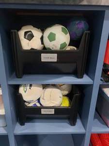 lot 1215 image: Contents of Shelf.  2 Totes Full of Socces balls & Volleyballs