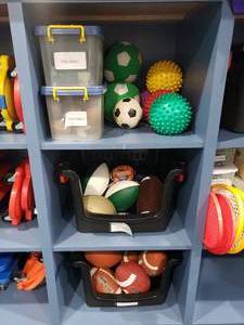 lot 1217 image: Contents of Shelf.  Lot of Footballs & Soccer Balls.