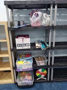 lot 1279 image: Contents of Shelf.  Adhesive Vinyl Rolls, Beach Themed Party Dcor, Sand Bucket Sets, Spin The Wheel & More.  SHELF NOT INCLUDED