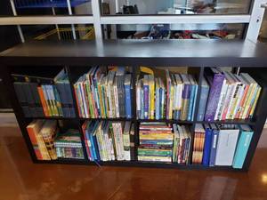 lot 1320 image: Ikea Kallax Black 8 Shelf Shelving Unit w Large Lot of Books.  Measures 59 x 31 x 15.  BUYER GETS SHELF & ALL BOOKS PICTURED.