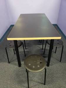 lot 1724 image: Black Table w 8 Stackable Plastic & Metal Stool Chairs.  Table Measures 59 x 30