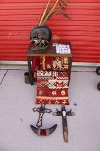 lot 46 image: Home dcor with side table. Includes Western style crosses, throw pillows, cowboy statue, tea lights and decorative vases