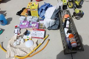 lot 52 image: Lightbulbs, Gas appliance connectors, storage hook set, smoke alarms, work gloves, Kwikset door handles in packaging