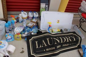 lot 88 image: Generous amount of cleaners and Laundry mat plus 24 2 inch faux wood blinds by Levolor still in box.