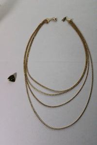 lot 105 image: Signed Amway 4-strand tiered necklace with figural A clasp. Marked Amway near spring ring clasp.16-22L. Also includes an Amway green enamel vintage lapel pin.