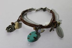 lot 112 image: Signed American Eagle leather bracelet with charmsdangles. Adjustable 7-8L. Has AEO hang tag.