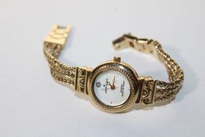 lot 116 image: Signed Anne Klein gold plated diamond watch with Mother of Pearl Face. Marked AK on clasp and Anne Klein Diamond on face. Model Y121E. 6.5L