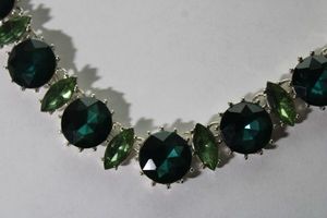 lot 117 image: Signed vintage Anne Klein prong set two-tone green faux Emerald crystal rhinestone statement collar necklace. 16L. Has Anne Klein hang tag.