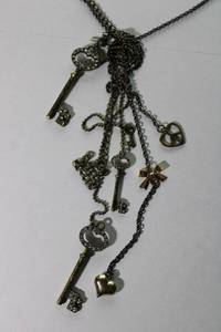 lot 121 image: Signed Betsey Johnson Necklace with pave crystal multiple key pendants. 26L with 3 extender. Overall length with keys 54. Marked with Betsey Johnson on one key and BJ heart hang tag.