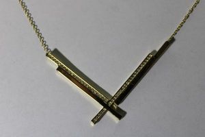 lot 129 image: Signed CC Skye (Chari Cuthbert, USA 2004- )gold plated and crystal necklace with V-formation pendant. Marked on toggle clasp. 16L