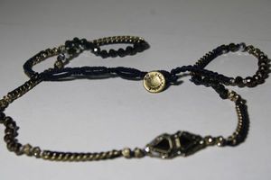lot 134 image: Signed Chloe & Isabel faceted glass, rhinestone and metal bead necklace. Marked on button clasp on woven necklace. 28L Heavy