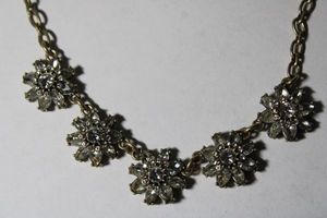 lot 135 image: Signed Chloe & Isabel faceted prong set crystal daisyflower necklace. Has signed bird hang tag, 14L with 2 extender. Lobster clasp.