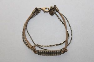 lot 136 image: Signed Chloe & Isabel chain and cord bracelet with baguette style crystals. Lobster clasp. Marked with a C & I round hang tag. 6.5L
