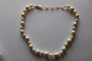 lot 138 image: Signed Carolee faux pearl necklace. Individually knotted with alternating sized pearls. Marked Carolee on heart tag. Lobster clasp. 14L with 2 extender