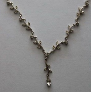 lot 139 image: Signed Carolee clear rhinestone Y-necklace in leaf form. Marked Carolee on heart extender cap. 14L with 3 extender.