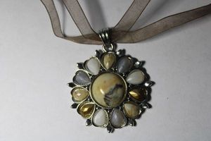 lot 149 image: Signed Cookie Lee fabric choker with faux stone pendant. Marked Cookie Lee on hang tag. 14L with 3 extender