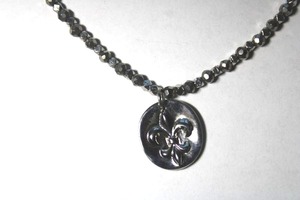 lot 150 image: Signed Cookie Lee faceted metal bead necklace with fleur de Lis pendant. Marked Cookie Lee on hang tag. 14L with 3 extender.