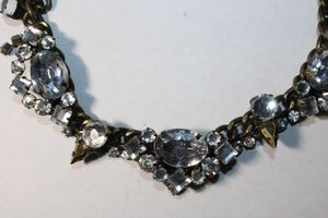 lot 165 image: Signed mixed industrial metal prong set rhinestone necklace. 14L. Lobster clasp. Marked with Express hang tag.