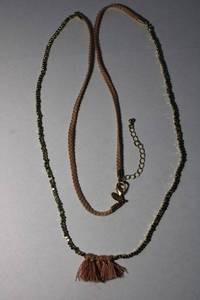 lot 166 image: Signed woven necklace with faceted metal beads and frayed yarn. Marked with Express hang tag. 34L with 2 extender