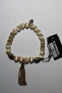 lot 169 image: Signed Express faux Cats Eye stretch bracelet with tassel. Has Express hang tag and original retail tag.