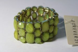 lot 175 image: Signed Forever 21 mintgold acrylic prong set stretch bracelet with retail tag.