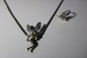 lot 177 image: Gun metal silver necklace with fairy pendant 16L Lobster clasp. Includes a Fairy ring Size 8.