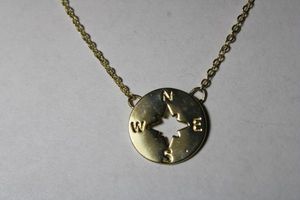 lot 188 image: Signed J Langford Gold plated Follow Your Journey compass pendant necklace. 16L with 2 extender. Signed in script on heart hang tag.